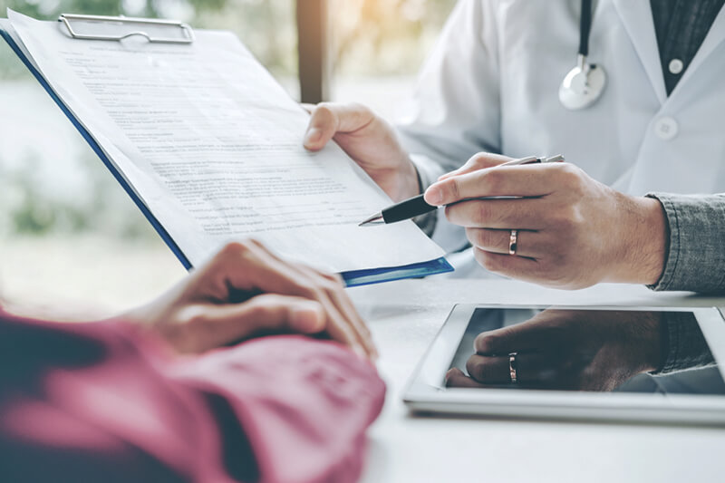 Consulting KAMG doctor with patient